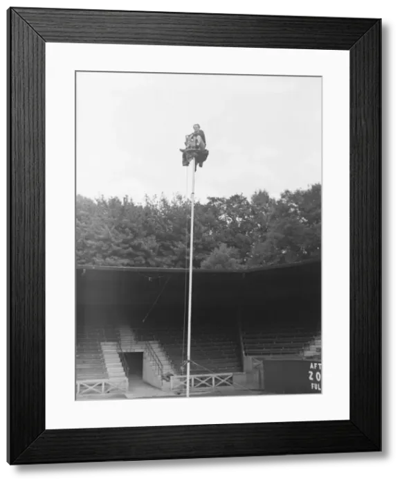 Framed Print : The Great Reno sitting on top of a 60 ft pole at Brighton Zoo after an arguement with his