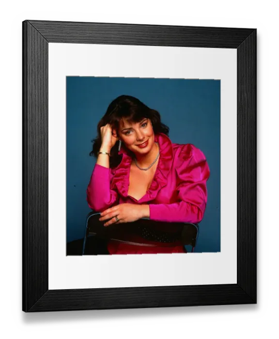 Framed Print : Nicola Bryant actress February 1985 wearing pink low cut shirt hand at head hair
