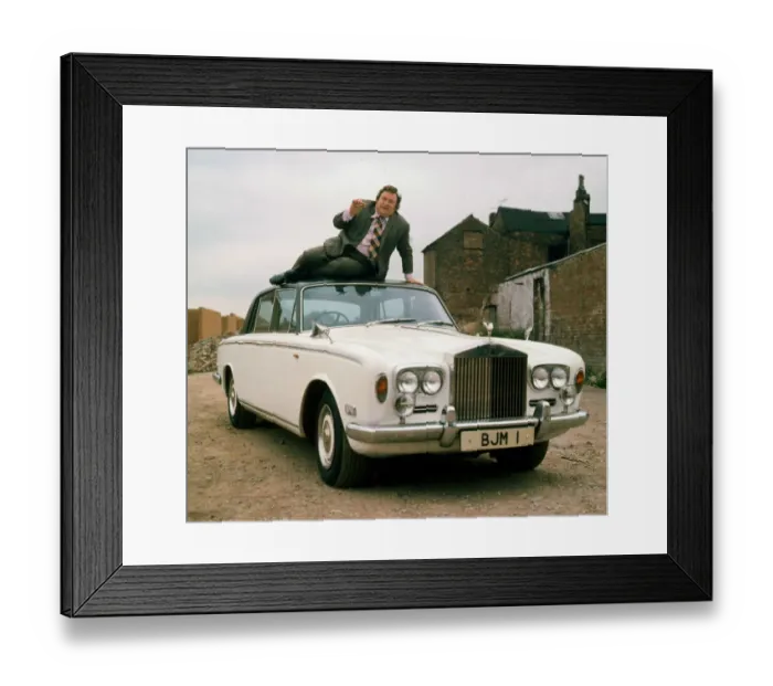 Framed Print : 00007433 Bernard Manning sitting on roof of Rolls Royce April 1981