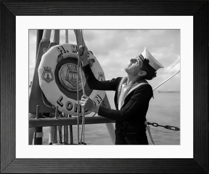 Framed Print : A naval rating raising the white ensign aboard the County Class cruiser HMS London which Framed Print : A naval rating raising the white ensign aboard the County Class cruiser HMS London which