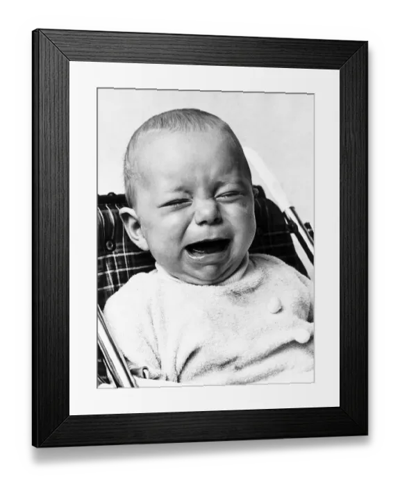 Framed Print : A baby crying as he sits in his high chair January 1973