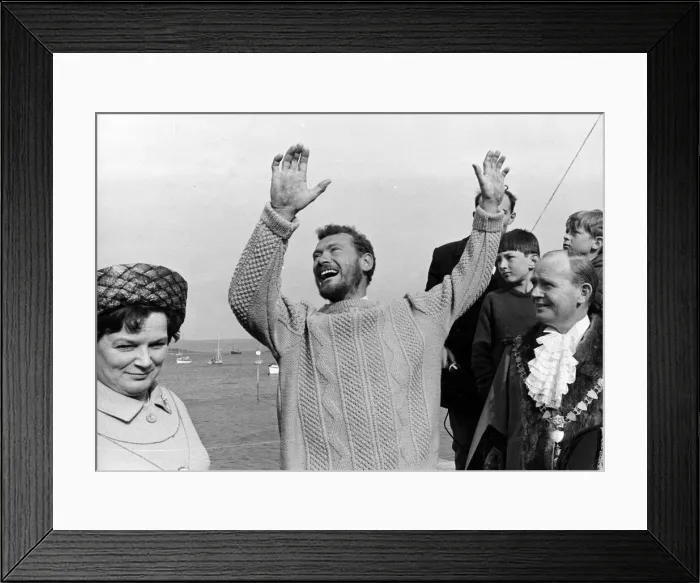 Framed Print : Robin Knox Jonston raises his arms in celebration as he comes ashore at Falmouth after