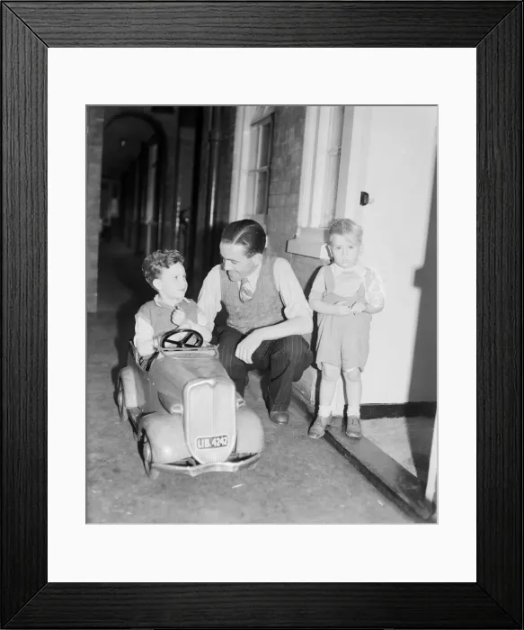 Framed Print : David Coles, whose wife is expecting quads playing with young son David in London Framed Print : David Coles, whose wife is expecting quads playing with young son David in London