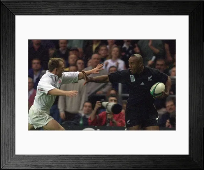 Framed Print : Jonah Lomu of New Zealand Oct 1999 hands off Matt Dawson of England on his way to