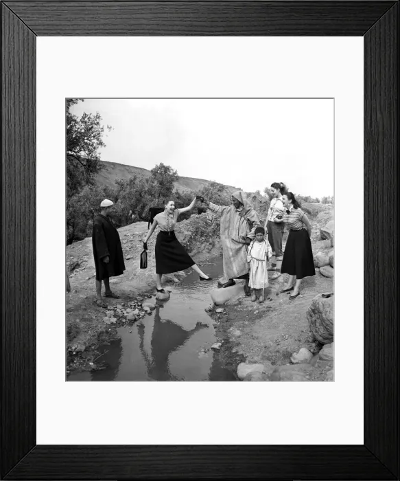 Framed Print : French actresses on a visit to Morroco speak to a local guide as he takes them Framed Print : French actresses on a visit to Morroco speak to a local guide as he takes them