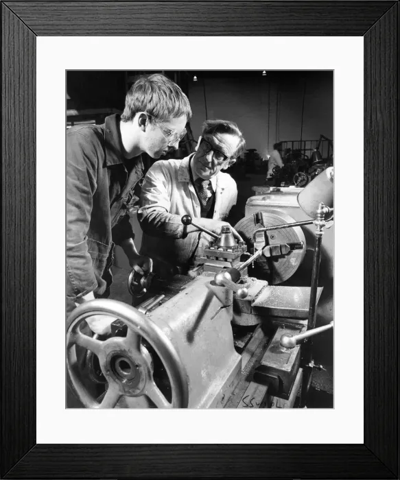 Framed Print : Instructor Bobby Hunter demonstrates lathe turning to apprentice Ian Summerville