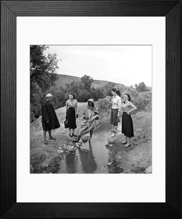 Framed Print : French actresses on a visit to Morocco speak to a local guide as he takes them Framed Print : French actresses on a visit to Morocco speak to a local guide as he takes them