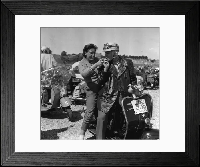 Framed Print : Scooter rally 1958 woman lighting cigarette for man A young woman lights Framed Print : Scooter rally 1958 woman lighting cigarette for man A young woman lights