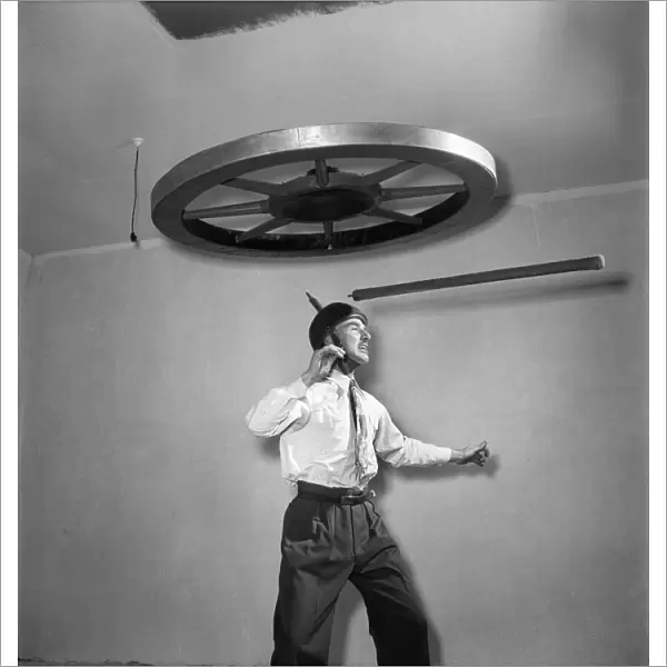 Henri Vadden holds an 80lb cartwheel on a pole which he then places on his chin
