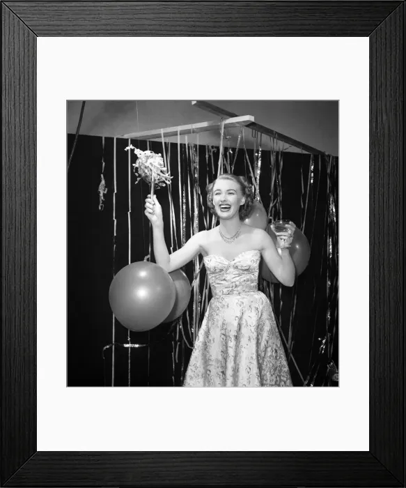 Framed Print : Susan celebrates the New Year with champagne and balloons January 1950 Framed Print : Susan celebrates the New Year with champagne and balloons January 1950