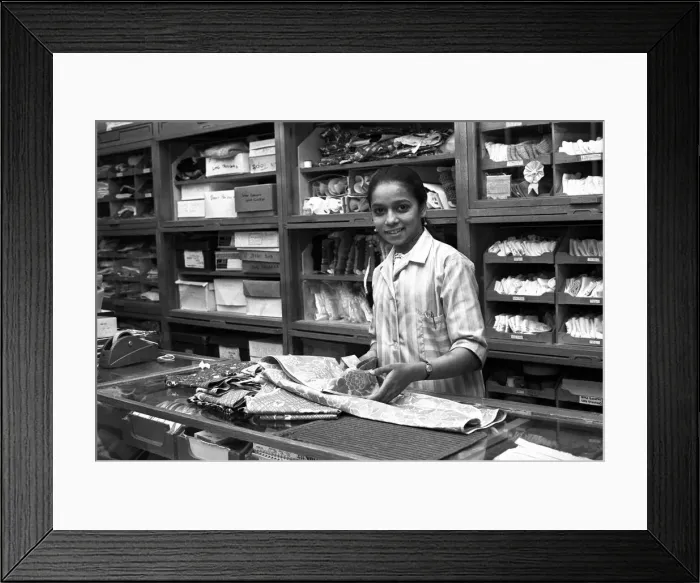 Framed Print : Asian woman working in a drapers shop in Smithford Way, Coventry Framed Print : Asian woman working in a drapers shop in Smithford Way, Coventry