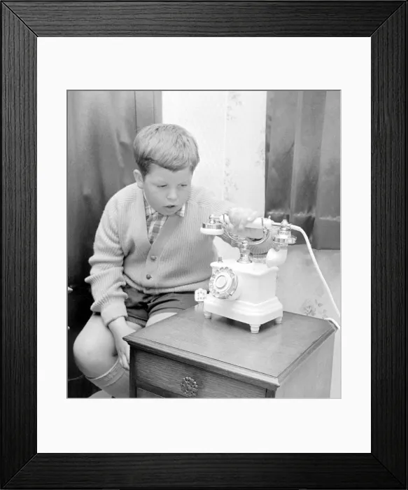 Framed Print : This young boy wait patiently for the telephone to ring. 20th June 1967 Framed Print : This young boy wait patiently for the telephone to ring. 20th June 1967