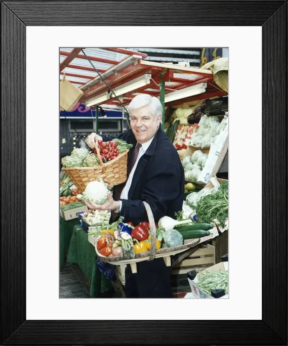 Framed Print : Robert Carrier TV chef Television Standing at a fruit stall Holding baskets of