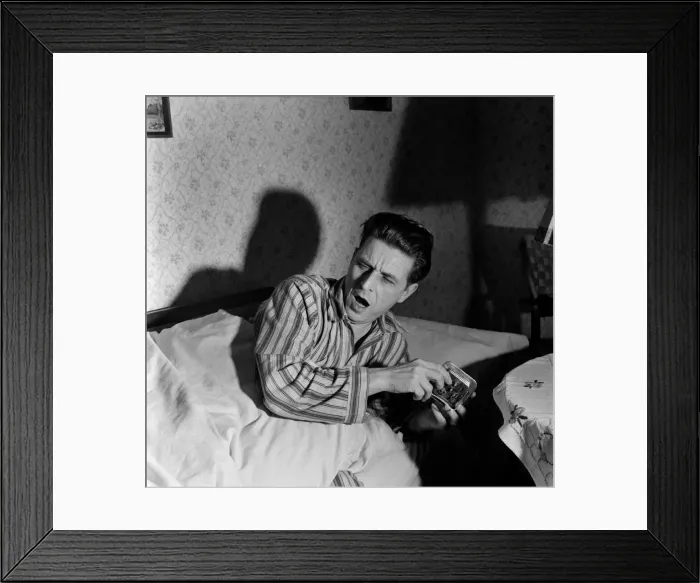 Framed Print : Man setting alarm clock before going too bed. December 1952 C6101-014 Framed Print : Man setting alarm clock before going too bed. December 1952 C6101-014