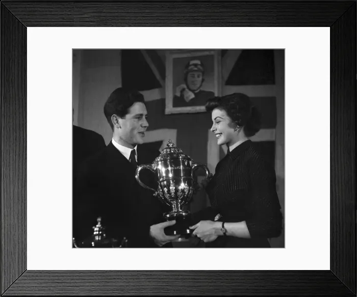 Framed Print : Motorcycle racing champion Geoff Duke shows the trophy to film star Joan Rice