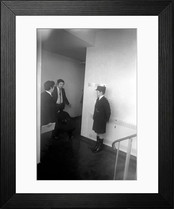 Framed Print : SDLP politician John Hume MP, being searched inside the county hall by police