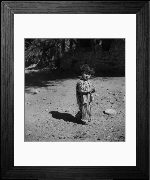 Framed Print : A child plays in the streets of Aqaba, trans - Jordan in his pyjamas Framed Print : A child plays in the streets of Aqaba, trans - Jordan in his pyjamas