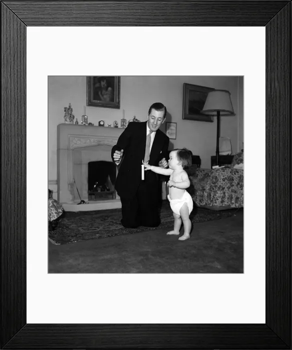 Framed Print : Illusionist Jon Evans seen here with a baby March 1952 C1112 Framed Print : Illusionist Jon Evans seen here with a baby March 1952 C1112