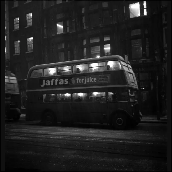 Fog scenes in the Strand. A London Transport bus seen here carrying commuters home