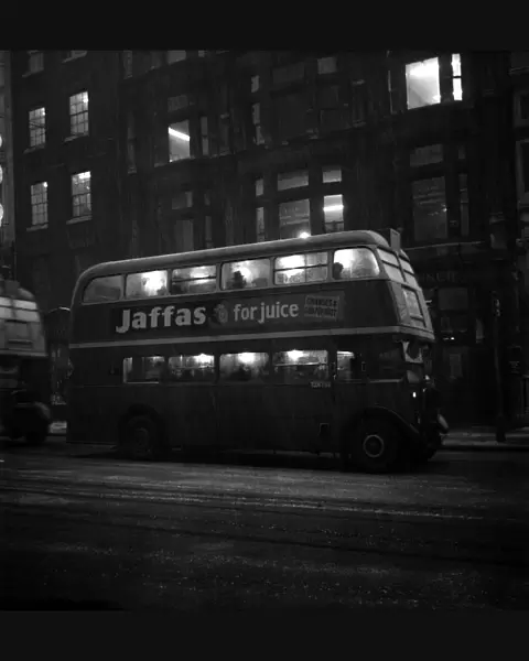 Fog scenes in the Strand. A London Transport bus seen here carrying commuters home