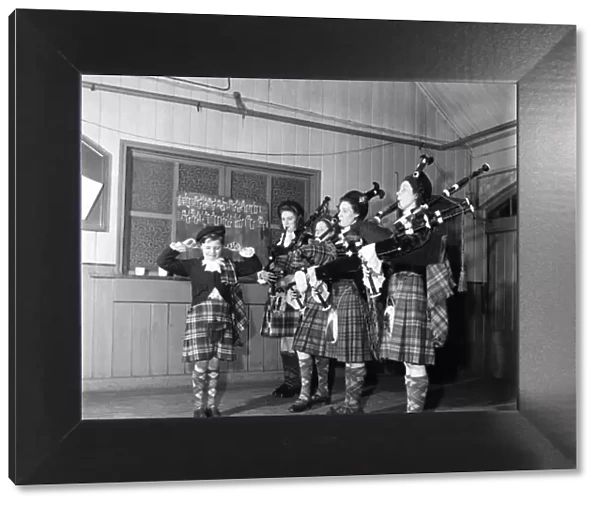 Donald Ross the Woolwich Pipe bands mascot, with his finers in his ears