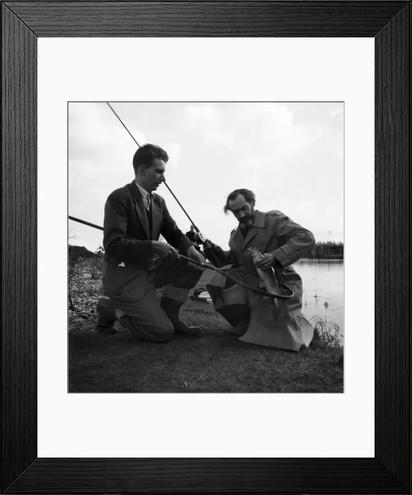Framed Print : Bernard Venables Daily Mirror fishing expert seen here discussing the catch with a fellow Framed Print : Bernard Venables Daily Mirror fishing expert seen here discussing the catch with a fellow