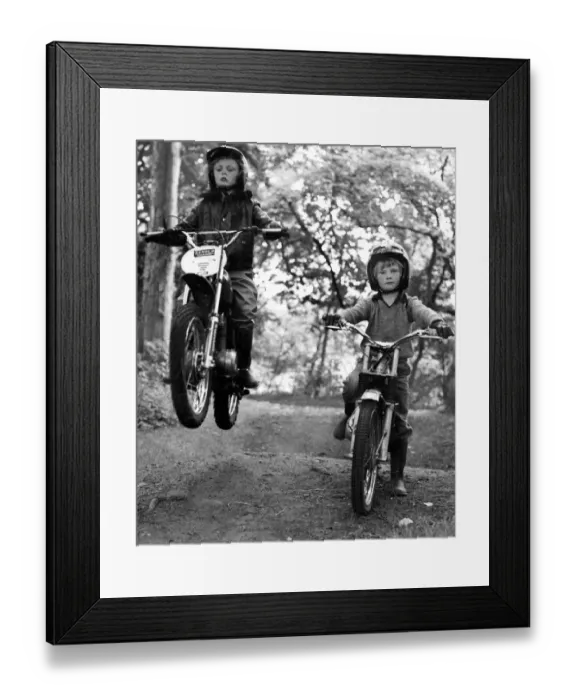 Framed Print : Two young boys Paul and Jason Wilson ride on their motorbikes on a woodland track Framed Print : Two young boys Paul and Jason Wilson ride on their motorbikes on a woodland track