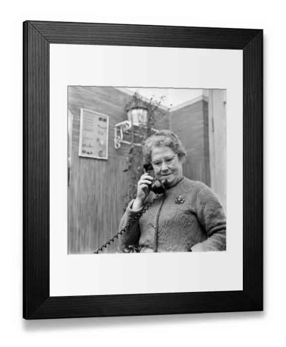 Framed Print : Woman talking on the telephone in her home. December 1969 Z11754-001