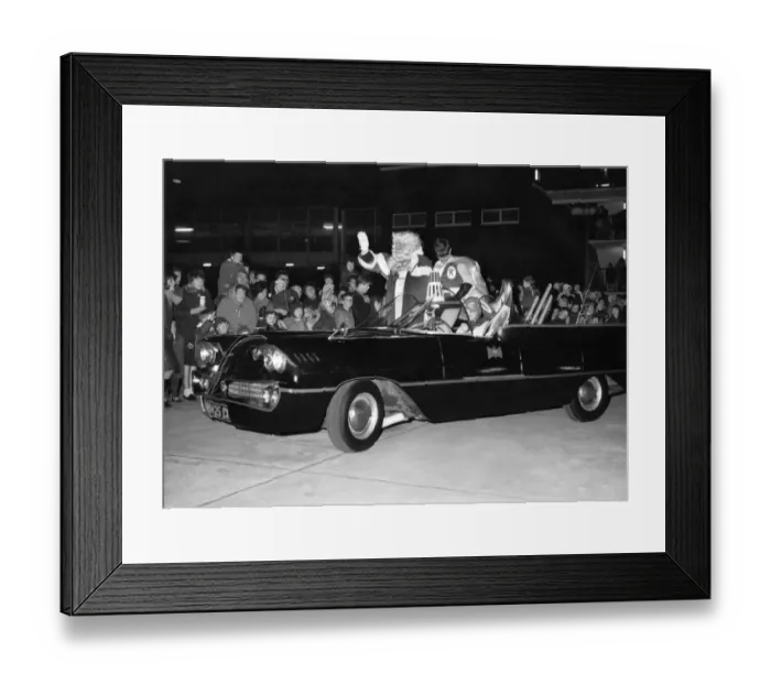 Framed Print : Batman and Robin escort Father Christmas safely into a city store as thousands of