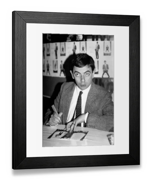 Framed Print : Rowan Atkinson sign copies of a Mr Bean video at HMV music store in Oxford Street