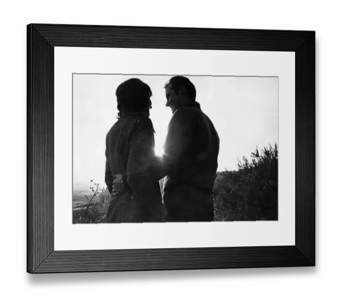 Framed Print : A young couple enjoy a cuddle in the countryside Framed Print : A young couple enjoy a cuddle in the countryside