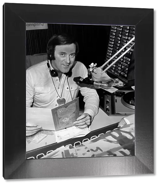 BBC Radio broadcaster Terry Wogan reading a Valentines card at his desk at the BBC