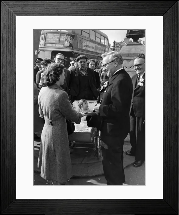 Framed Print : Mr. Herbert Morrison chats with housewife and baby Allen from Forest Hill who was Framed Print : Mr. Herbert Morrison chats with housewife and baby Allen from Forest Hill who was