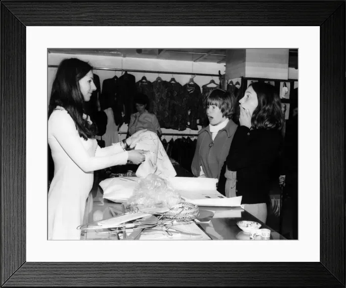 Framed Print : Shoppers are stunned when told clothes are free at the Apple Boutique close down sale