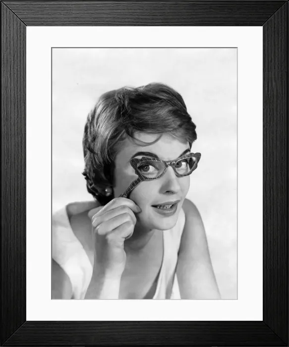 Framed Print : Glasses fashions. Model wears hand-held glasses. December 1957 P018651