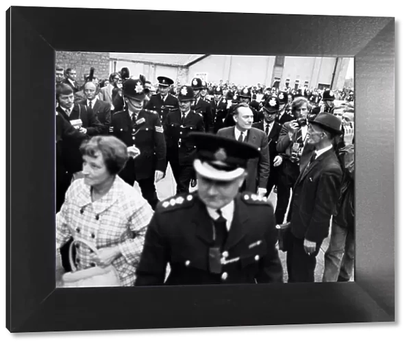 A police escort surrounds controversial Tory candidate Enoch Powell when he arrived to