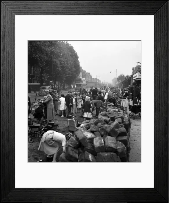 Framed Print : Adults and children collecting road blocks in Camberwell where the tram lines are being