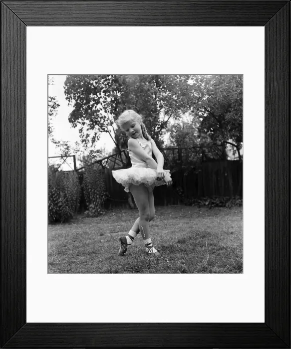 Framed Print : Young girl Penny Brown practising her Ballet dancing wearing a tutu in the back garden Framed Print : Young girl Penny Brown practising her Ballet dancing wearing a tutu in the back garden