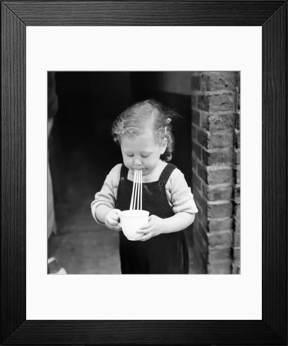 Framed Print : Little girl drinks through 4 straws. September 1952 C4389 Framed Print : Little girl drinks through 4 straws. September 1952 C4389