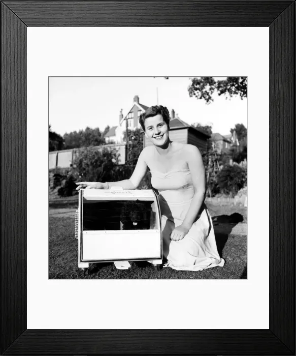 Framed Print : Miniature French Poodle seen here in her mobile kennel with mistress Miss Barbara