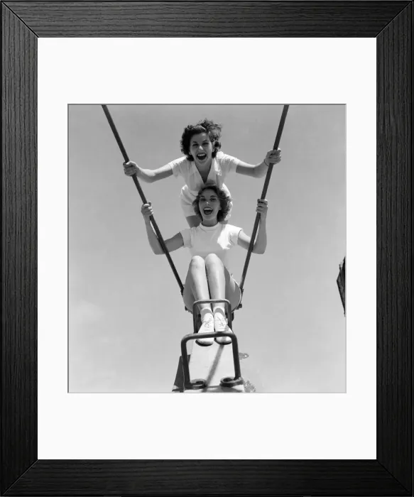 Framed Print : Friends enjoying the swings at a holiday camp. Holiday scenes Framed Print : Friends enjoying the swings at a holiday camp. Holiday scenes