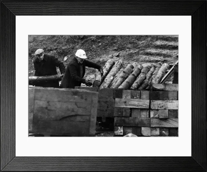 Framed Print : Two miners load up a truck with pit props ready for the next days work Framed Print : Two miners load up a truck with pit props ready for the next days work