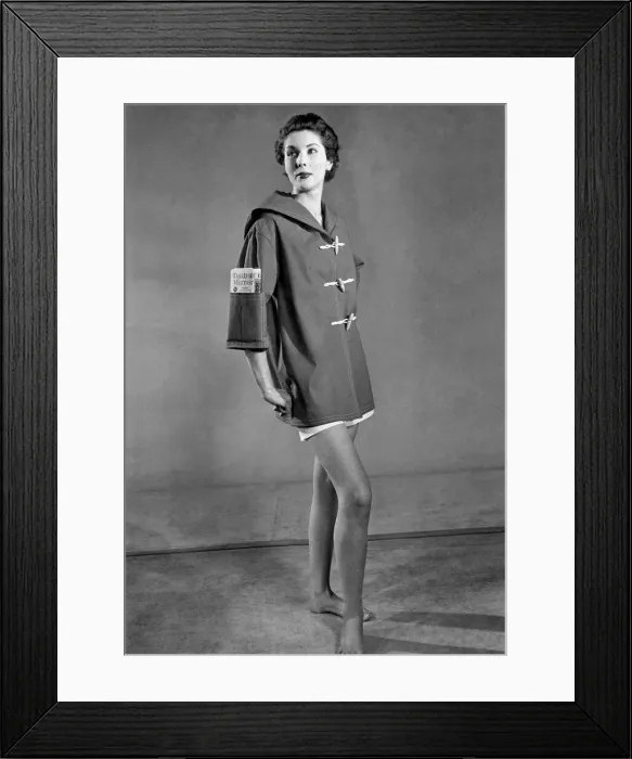 Framed Print : Clothing Beach. Woman wears duffel coat with handy pocket in the sleeve