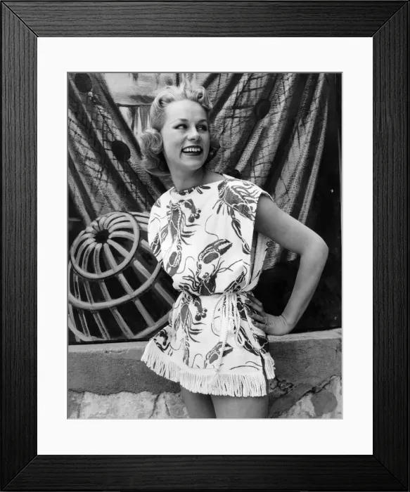 Framed Print : Woman wearing a patterned sleeveless short skirted outfit for a day out to the beach