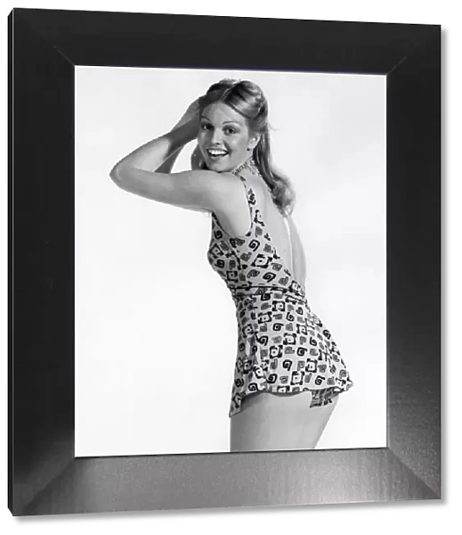 Model wearing a one piece swimsuit with skirt. July 1974 P018049