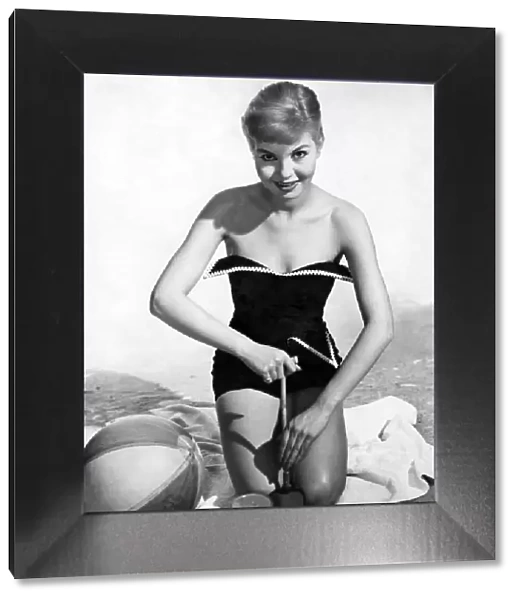 Model wearing a one piece swimsuit. May 1957 P018062