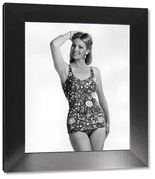 Model wearing a one piece swimsuit with skirt. July 1974 P018048