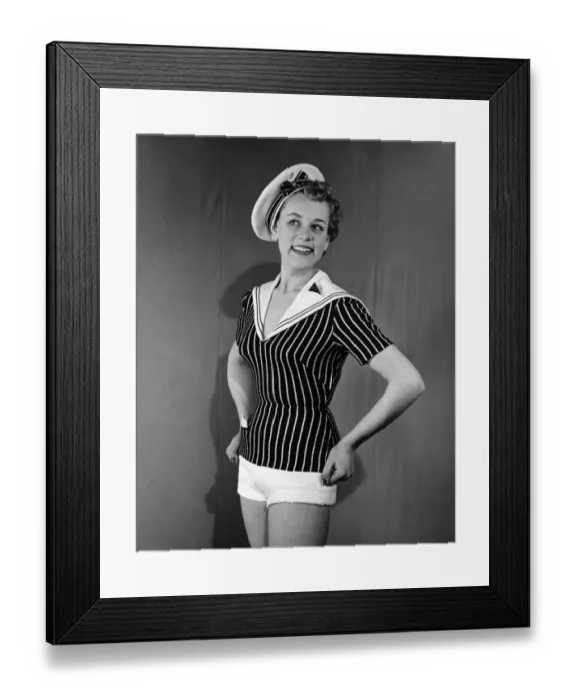 Framed Print : Clothing Beachwear. Model wears sailors hat, striped fitted naval style top Framed Print : Clothing Beachwear. Model wears sailors hat, striped fitted naval style top