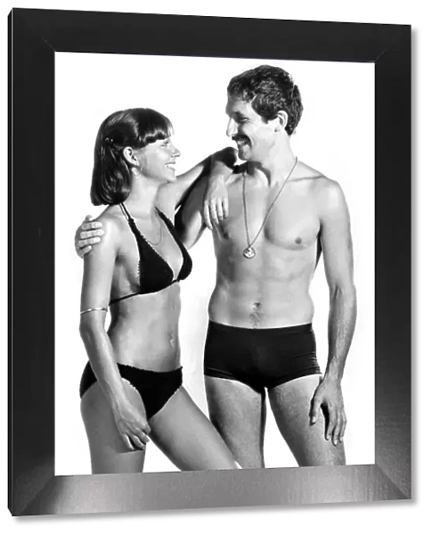 Woman wearing a bikini poses with a man in swimming trunks