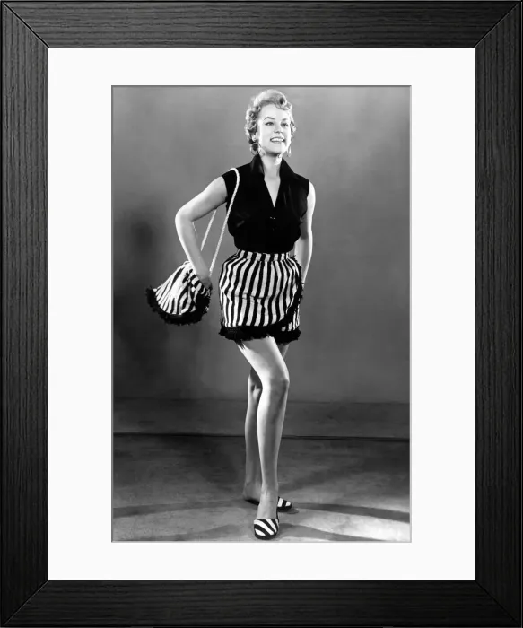 Framed Print : Woman dressed up for aday out at the beach, wearing sleveless top and striped skirt Framed Print : Woman dressed up for aday out at the beach, wearing sleveless top and striped skirt